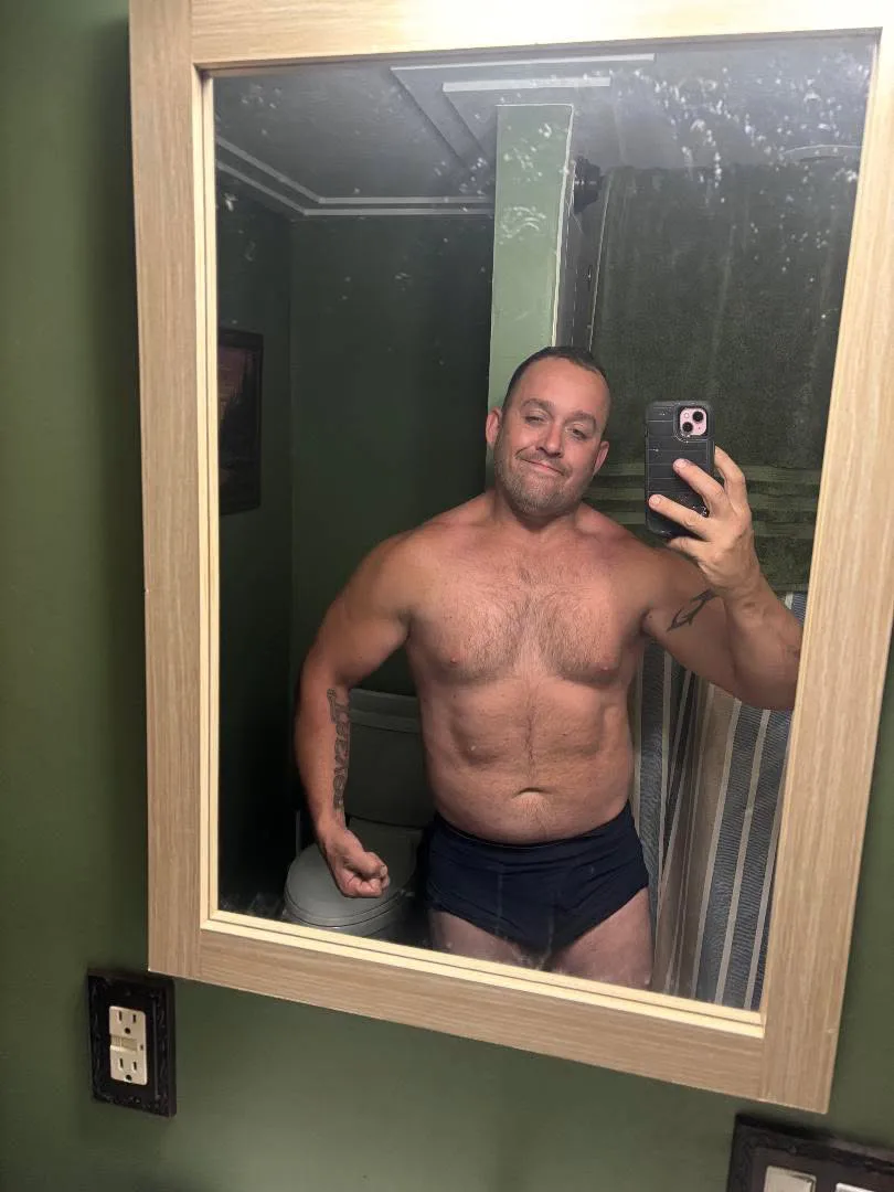 The same client photographed in the same mirror after coaching