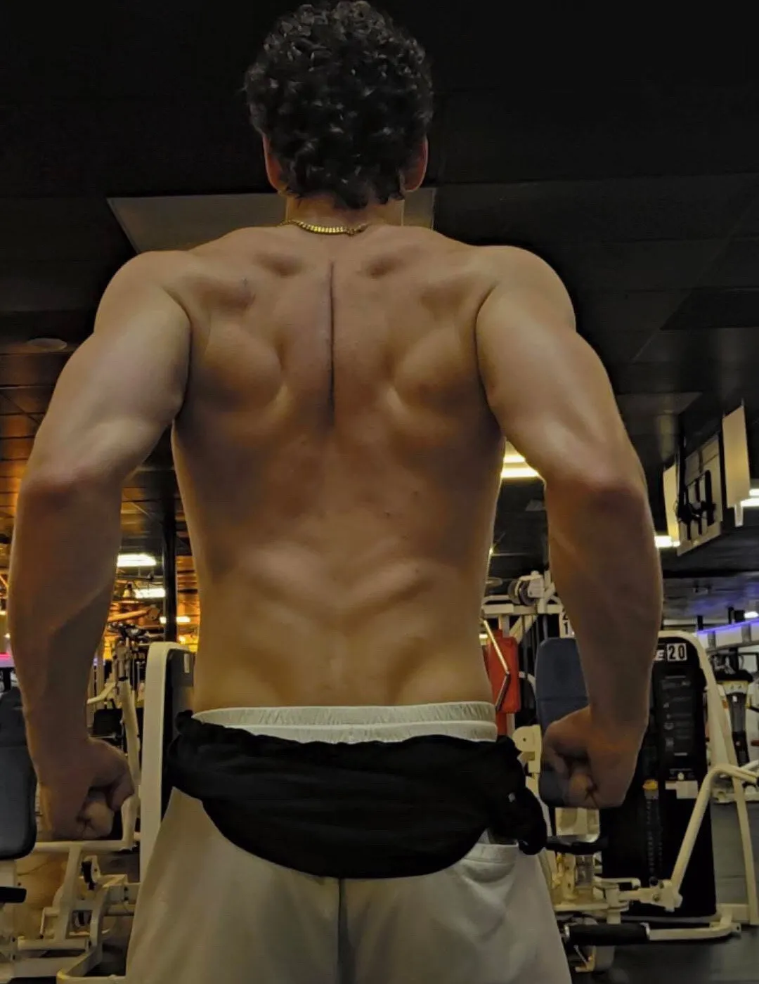 Sam standing with his back to camera on the gym floor
